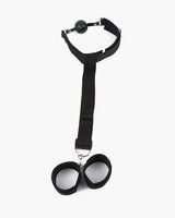 Adjustable black restraint set with ball gag and wrist restraints for intimate exploration.