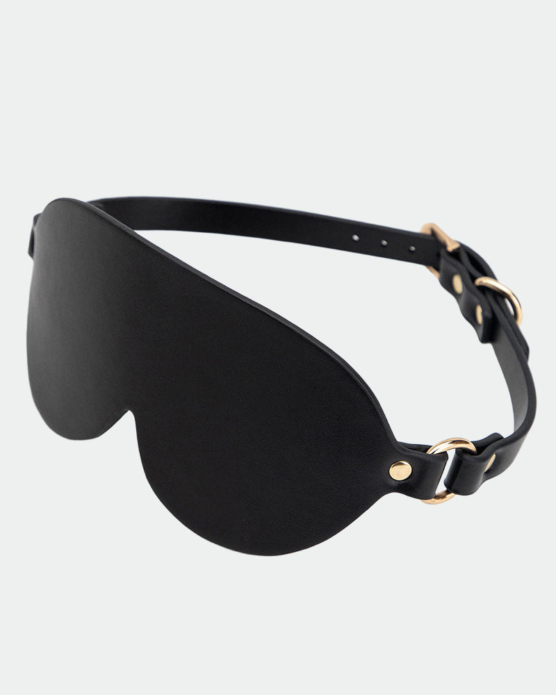 Black leather sunshade eye mask with gold hardware for intimate sessions