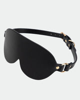 Black leather sunshade eye mask with gold hardware for intimate sessions