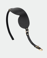 Black leather eye mask with gold hardware and adjustable strap for sensual exploration.