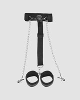 Black SM supplies set: gag ball, neck strap, chains, and wrist cuffs for intimate exploration.