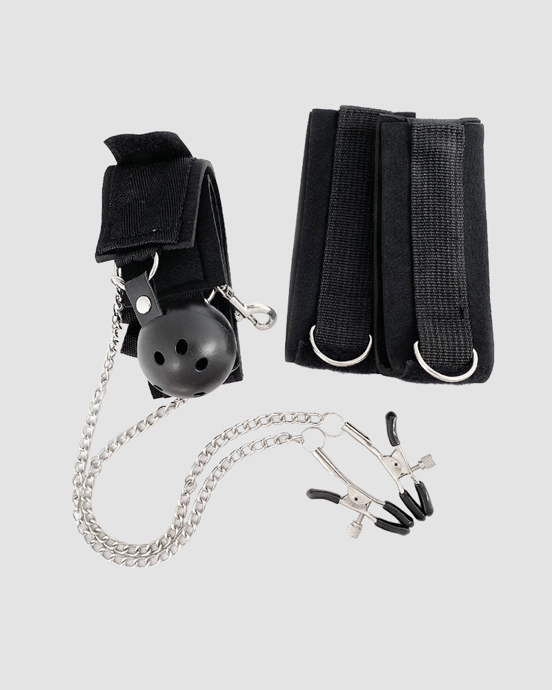 Black SM bondage set with gag ball, wrist cuffs, nipple clamps and chain for intimate exploration.