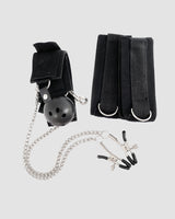 Black SM bondage set with gag ball, wrist cuffs, nipple clamps and chain for intimate exploration.