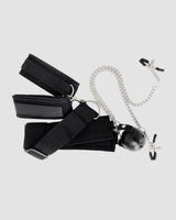 Black SM bondage set with wrist cuffs, ball gag, nipple clamps, and chain for intimate exploration.