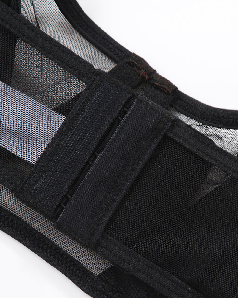 Black mesh push-up bra detail with adjustable straps and hook closure. Seductive lingerie.