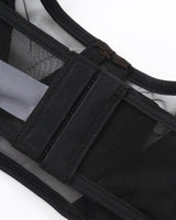 Black mesh push-up bra detail with adjustable straps and hook closure. Seductive lingerie.