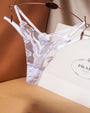 White Rose Embroidery Thong Mesh Panty with floral lace design, Prada shopping bag background