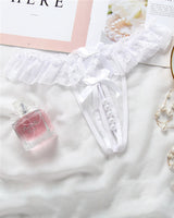 White lace crotchless panty with faux pearls, low rise design, and bow accents. Sexy lingerie.