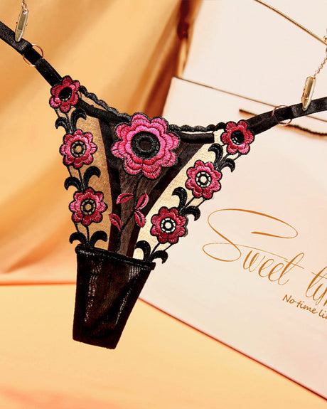 Embroidered black lace thong panties with pink flowers. Sexy low waist lingerie.
