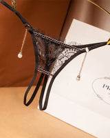Black lace crotchless thong with pearl pendant. Low waist, floral design. Sexy lingerie.