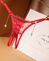 Red crotchless thong with pearl pendant and floral lace. Low waist design. Sexy lingerie.