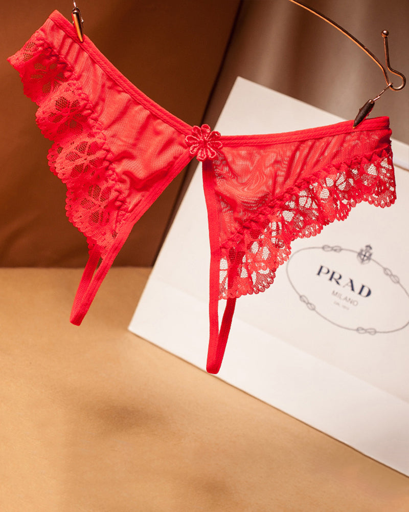 Red lace crotchless thong with floral design, low waist, Prada shopping bag background